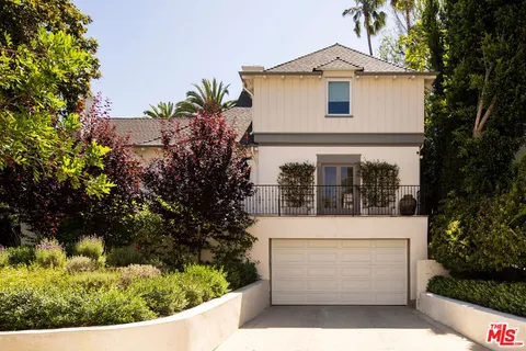 a view of entrance of house and tree