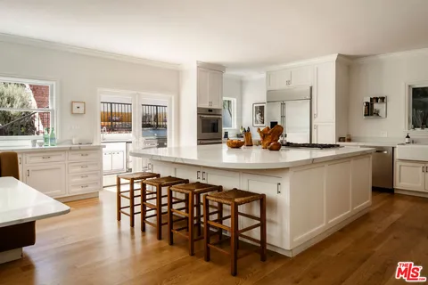 a kitchen with a table chairs stove and cabinets