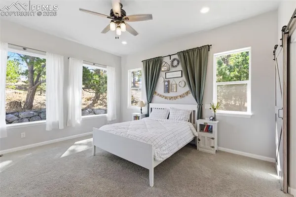 a bedroom with a bed and a flat screen tv in it