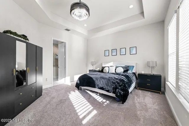 a bedroom with a large bed and a large window