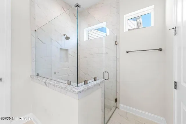 a bathroom with a glass shower door