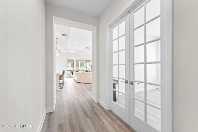 a view of a walk in closet with wooden floor