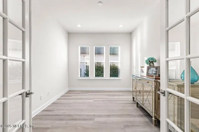 a view of an entryway with wooden floor