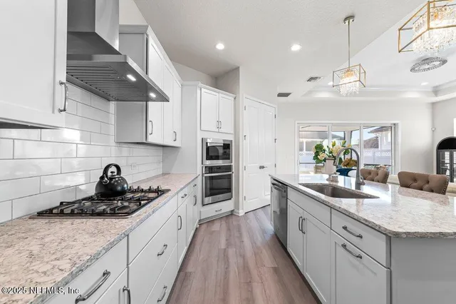 a kitchen with a sink stove and cabinets