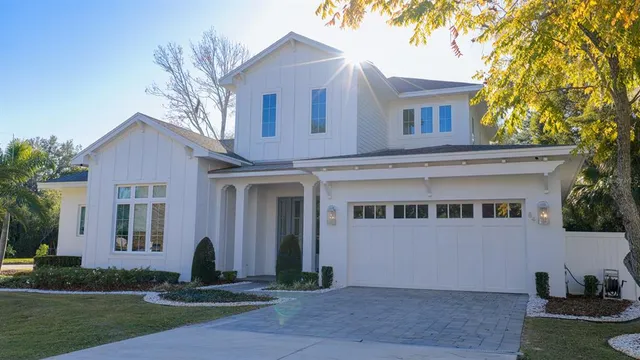 a front view of a house with a yard and a garage