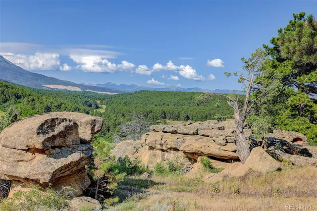 a living room with furniture kitchen and a chandelier