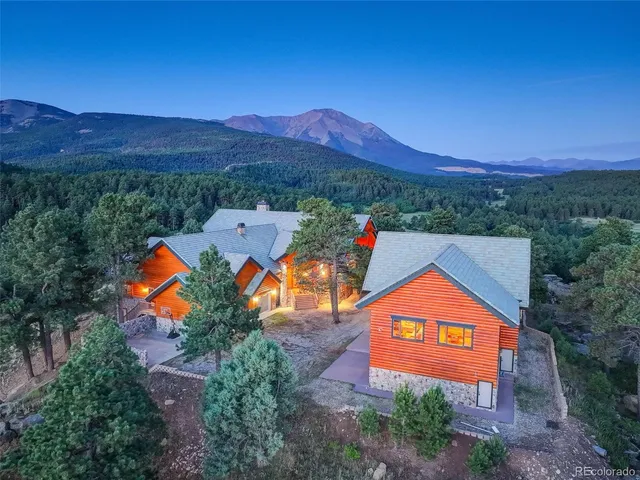 a bedroom with furniture and a large window