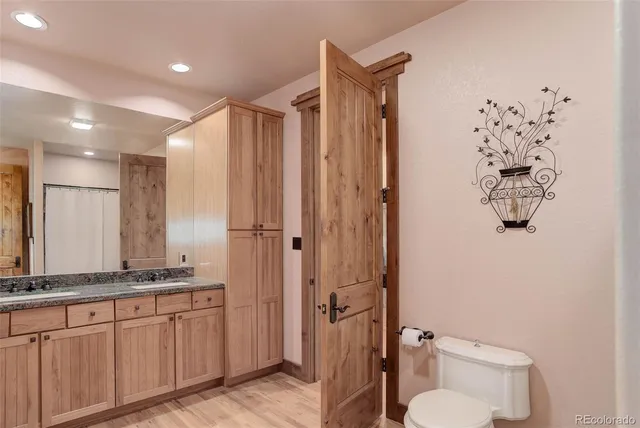 a spacious bathroom with a granite countertop sink toilet and shower