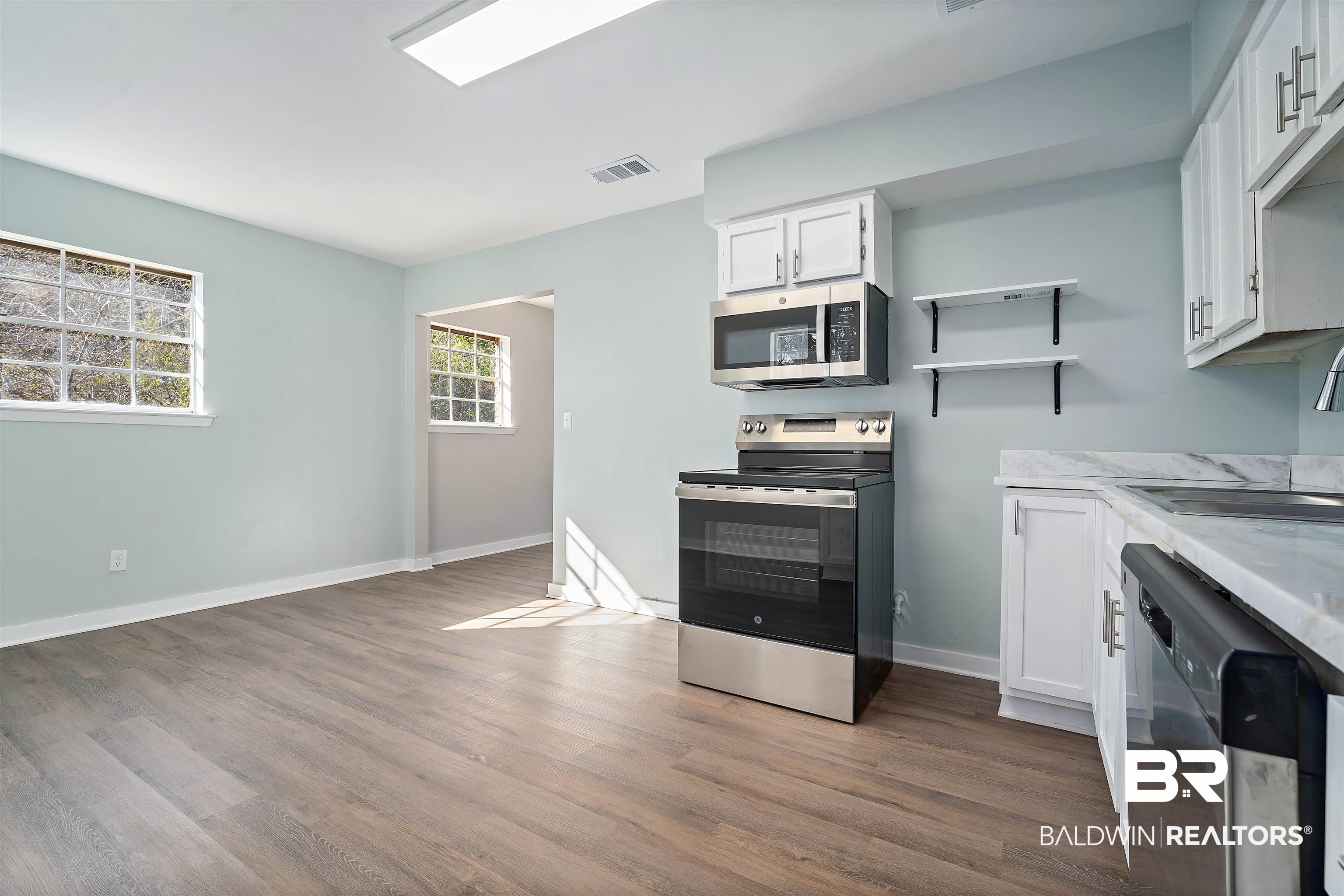 1368 Hubert Pierce Road Mobile, AL 36608 - Photo 11 of 25 Kitchen featuring white cabinetry, stainless steel appliances, dark wood-style flooring, open shelves, and light stone countertops