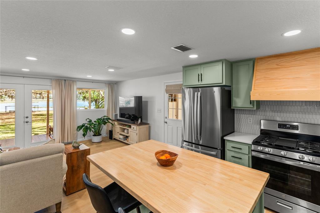 5921 County Road 352 Keystone Heights, FL 32656 - Photo 37 of 73 a kitchen with sink a refrigerator and chairs