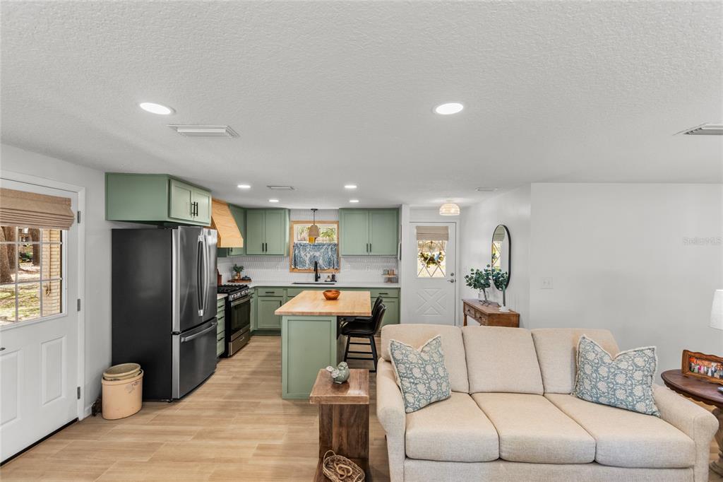 5921 County Road 352 Keystone Heights, FL 32656 - Photo 45 of 73 a living room with furniture and a refrigerator