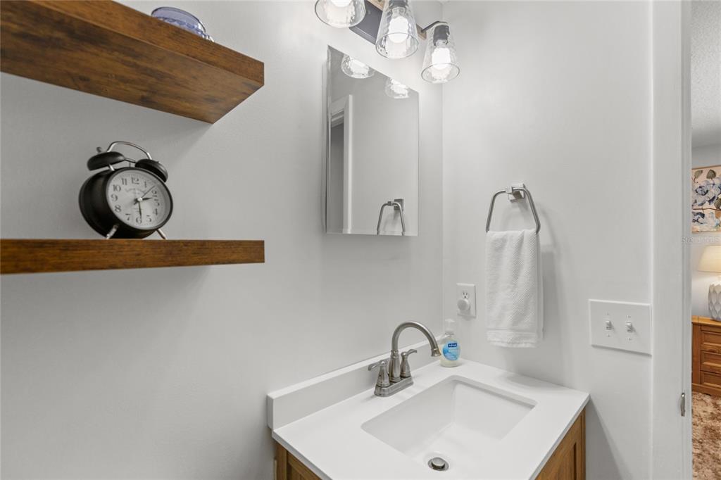 5921 County Road 352 Keystone Heights, FL 32656 - Photo 55 of 73 a bathroom with a sink and a mirror