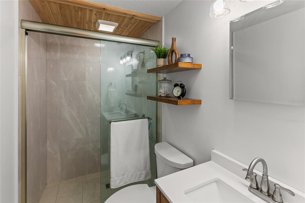 5921 County Road 352 Keystone Heights, FL 32656 - Photo 56 of 73 a bathroom with a toilet a sink and shower