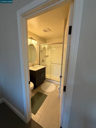 a bathroom with a double vanity sink a mirror and a shower