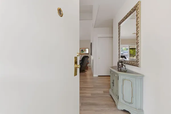 wooden floor with a mirror in a room