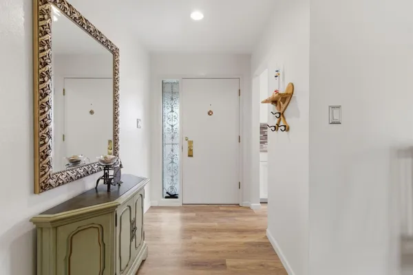 a kitchen with white cabinets and window