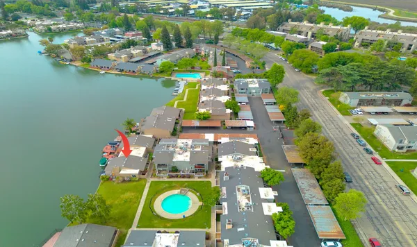 an aerial view of a house with a lake view