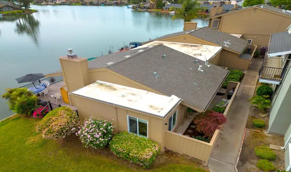 an aerial view of a house with a yard and a pool