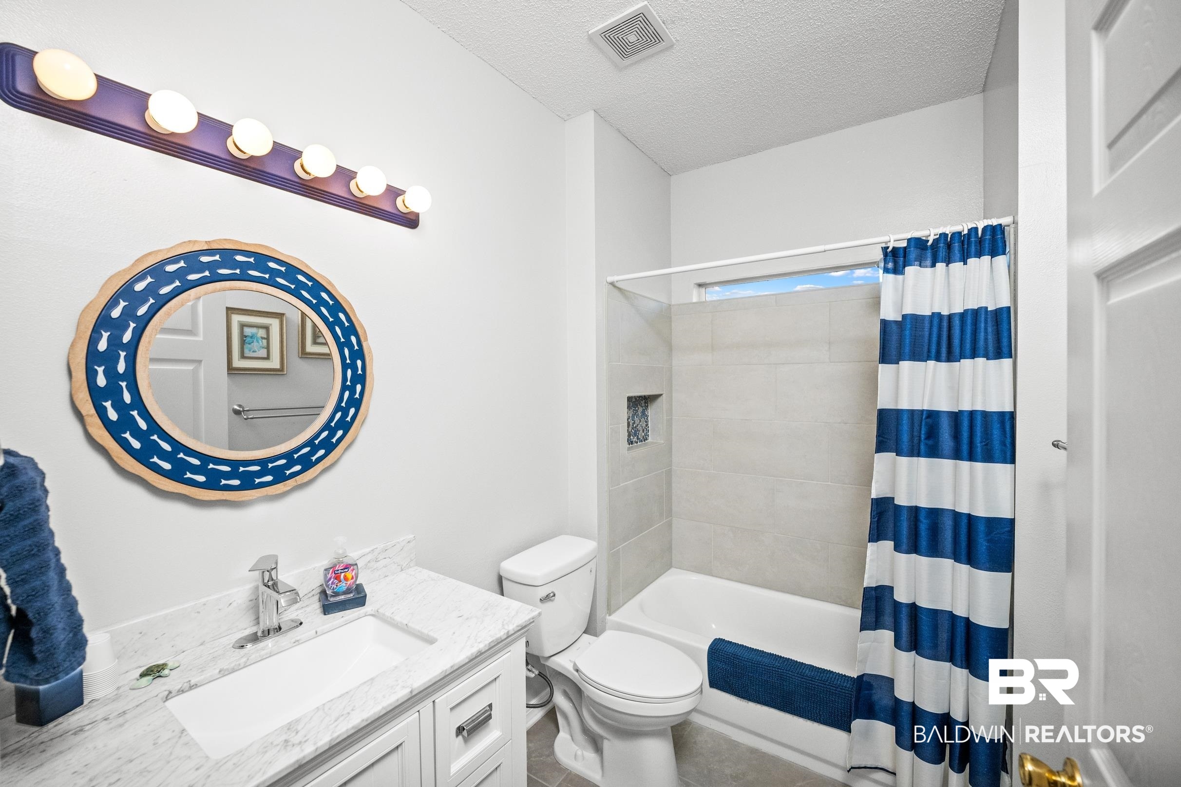 22355 East County Road 12 Foley, AL 36535 - Photo 37 of 54 Bathroom featuring vanity, a textured ceiling, and shower / bath combination with curtain