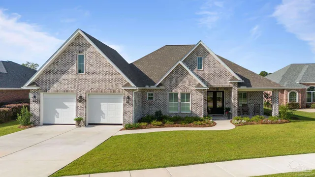 a view of a livingroom with a furniture chandelier wooden floor and a large window