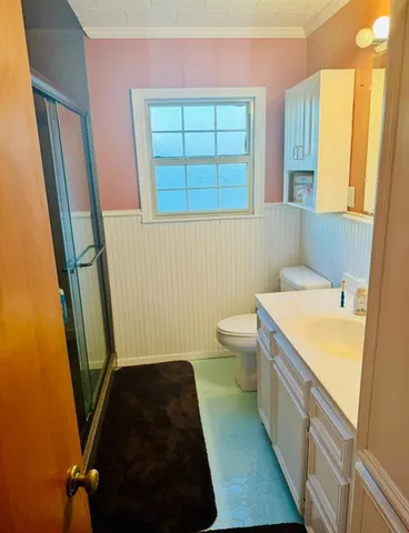 a bathroom with a sink a toilet and a window