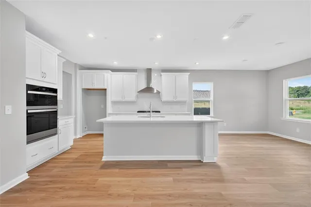 a view of kitchen with stainless steel appliances granite countertop a stove a sink and a refrigerator