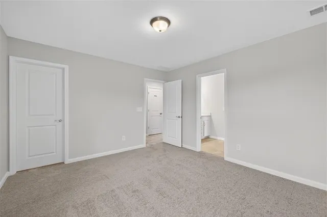 a view of an empty room with a closet