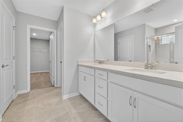a bathroom with double sink and a mirror