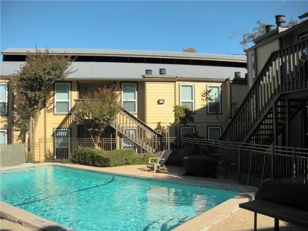 a view of house with backyard and glass door