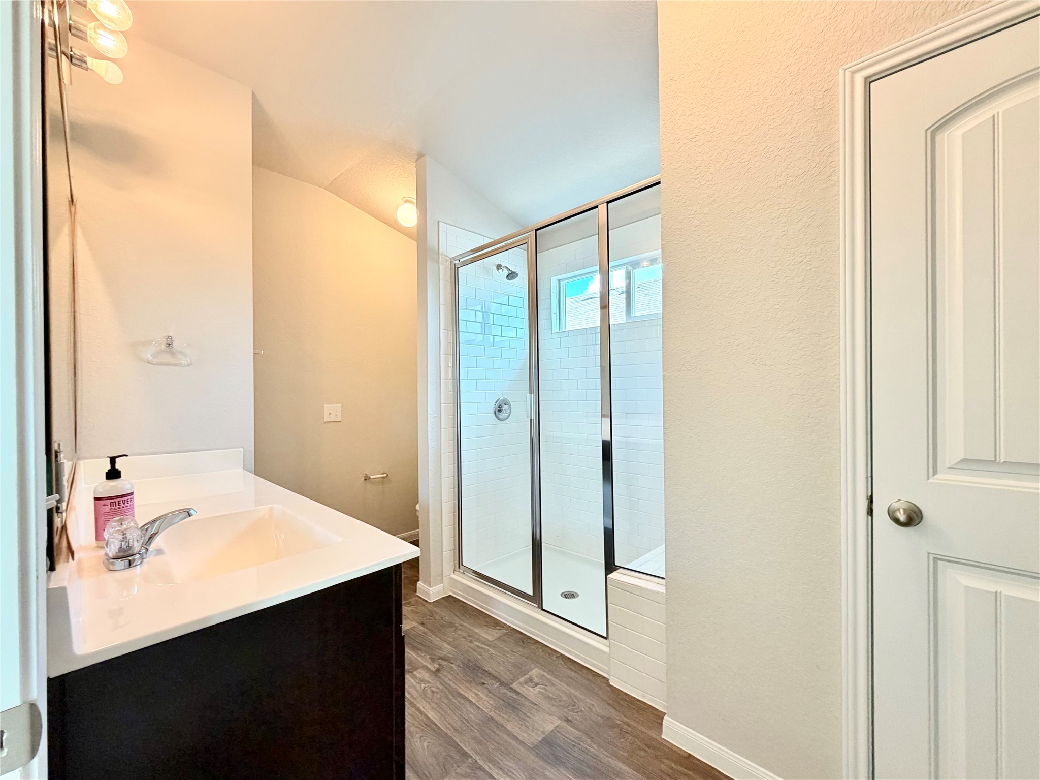 10502 Fulton Avenue Austin, TX 78754 - Photo 20 of 36 A sleek vanity and walk-in shower elevate this contemporary bathroom space.