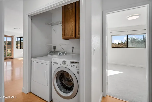 a view of a hallway with washer and dryer