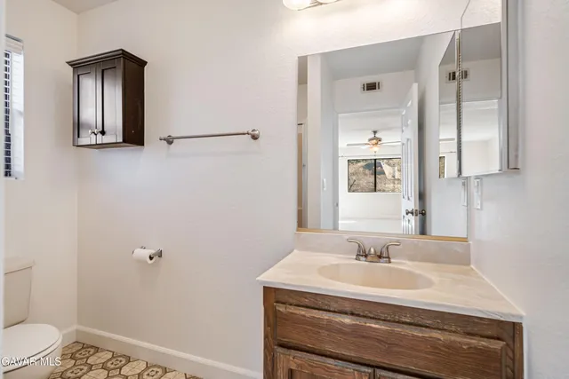 a bathroom with a toilet a sink and a shower
