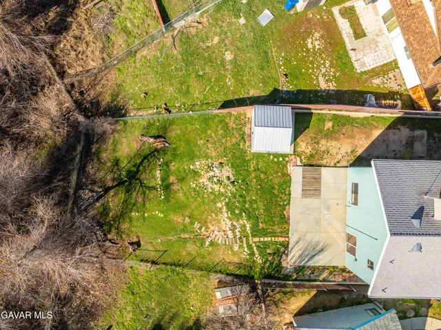 a aerial view of residential houses with yard