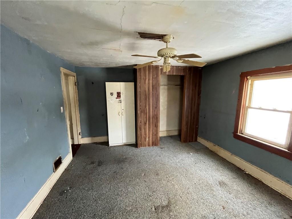 539 5th Street Colver, PA 15927 - Photo 12 of 13 an empty room with chandelier fan and windows