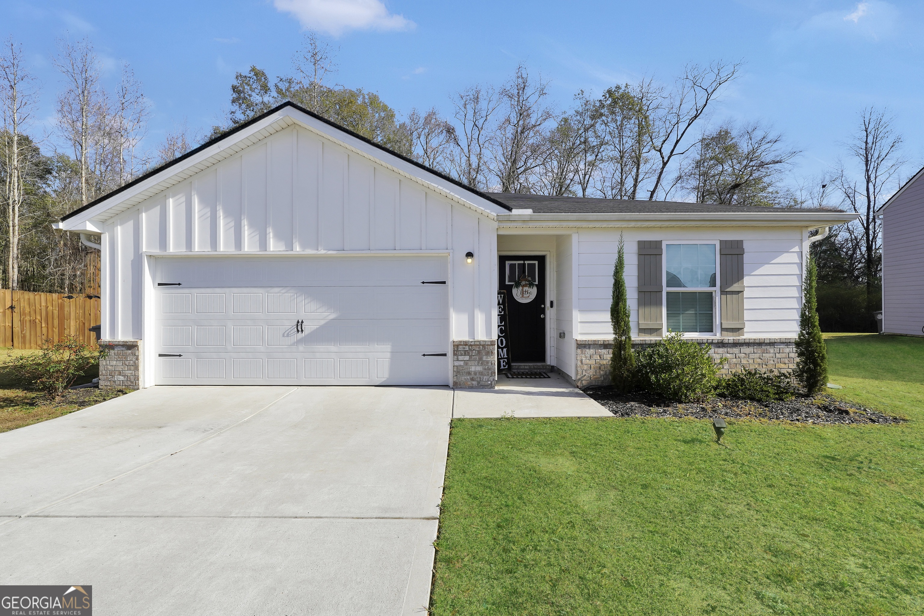 135 Catalpa Road Milner, GA 30257 - Photo 1 of 29 a front view of a house with a yard and garage