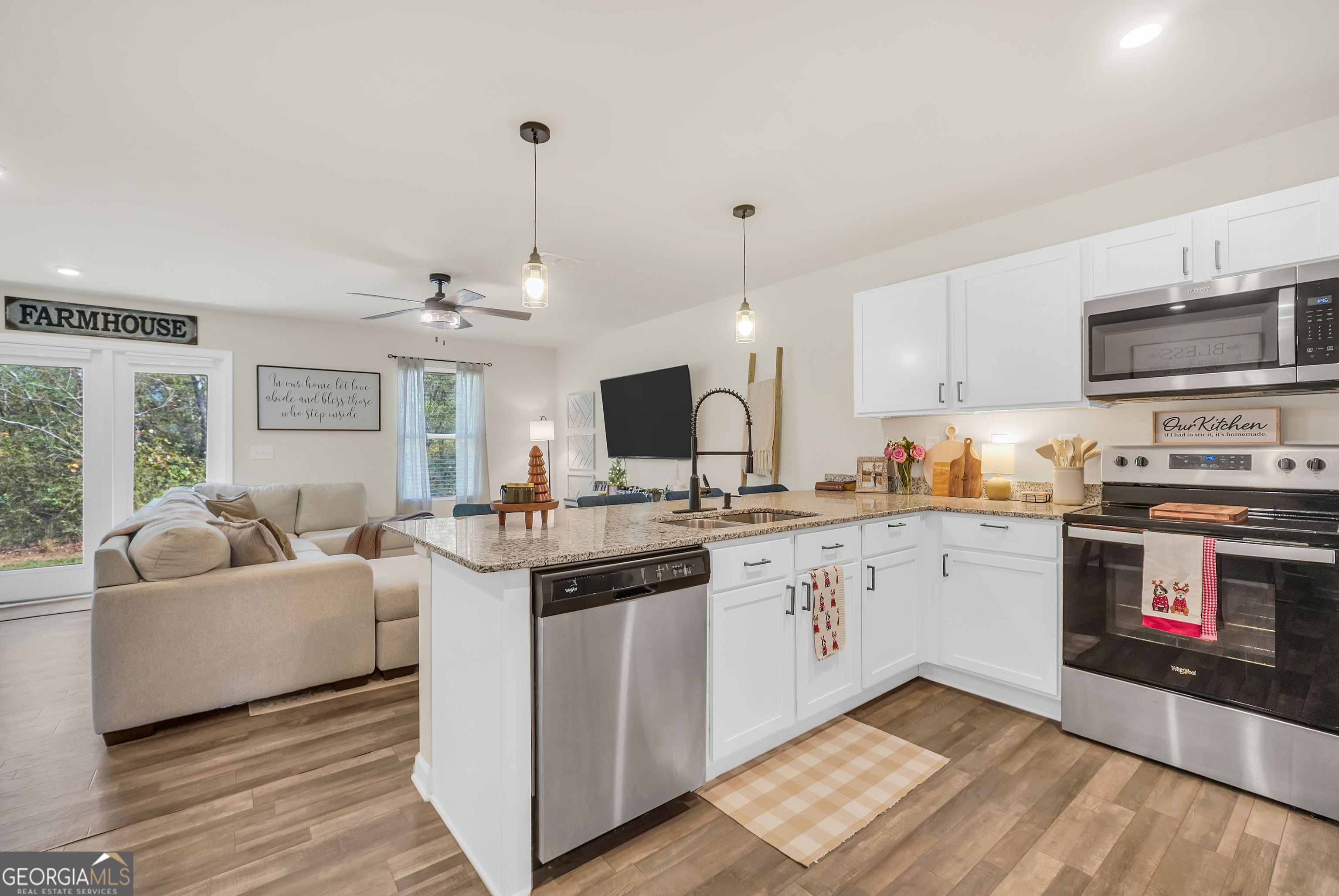 135 Catalpa Road Milner, GA 30257 - Photo 12 of 29 a kitchen with stainless steel appliances granite countertop a stove and a sink