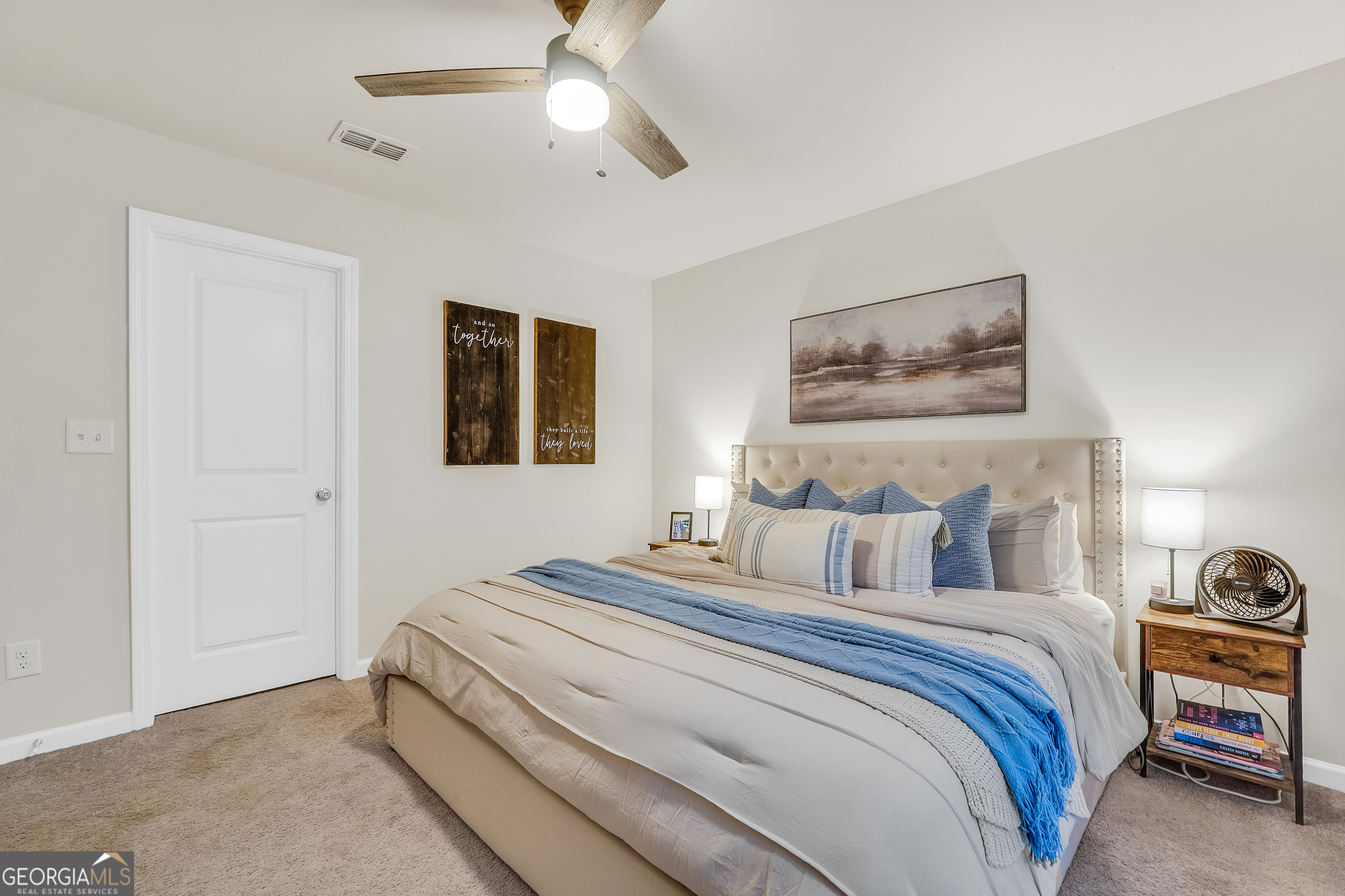 135 Catalpa Road Milner, GA 30257 - Photo 17 of 29 a bedroom with bed and a chandelier