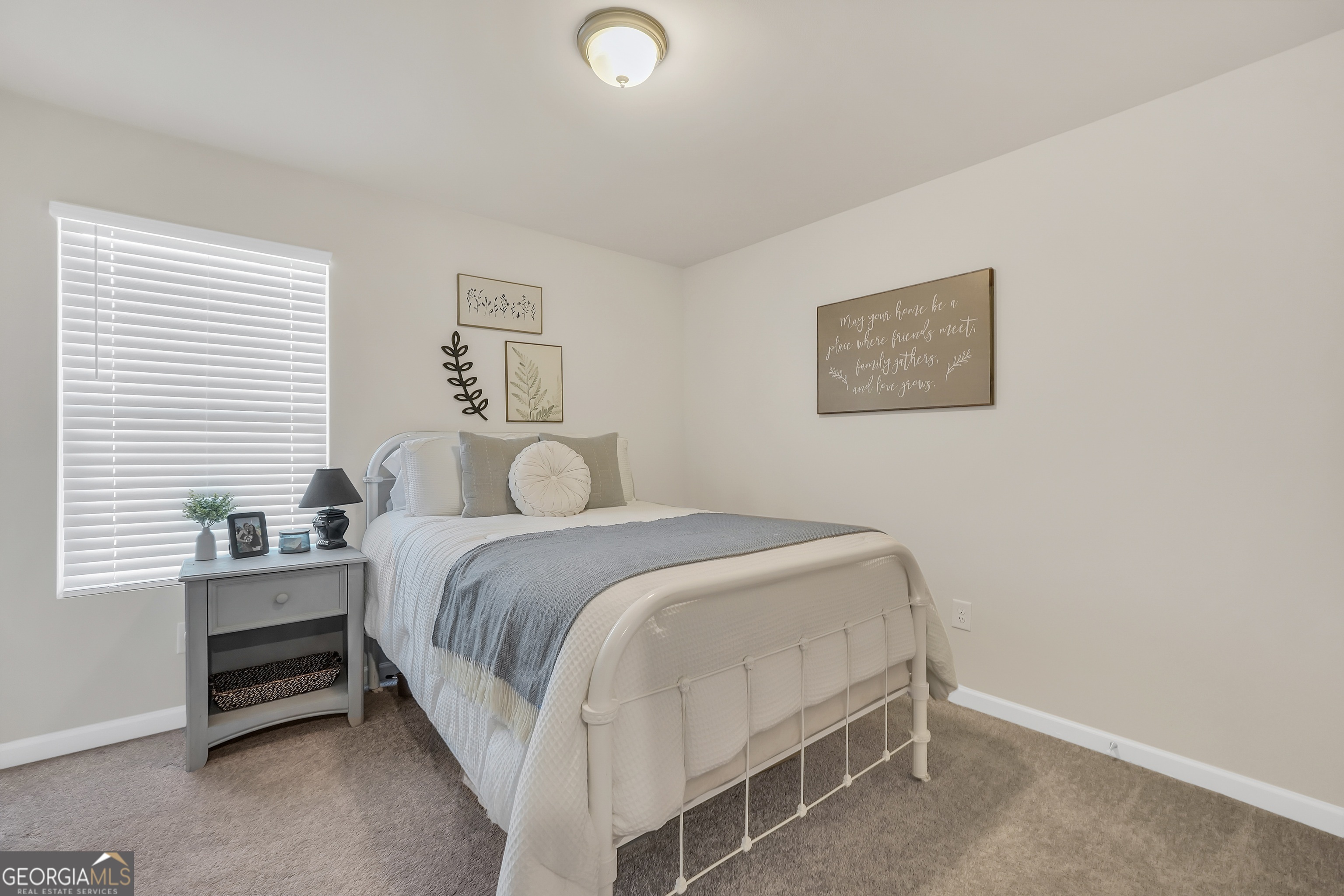 135 Catalpa Road Milner, GA 30257 - Photo 26 of 29 a bedroom with a bed and a desk