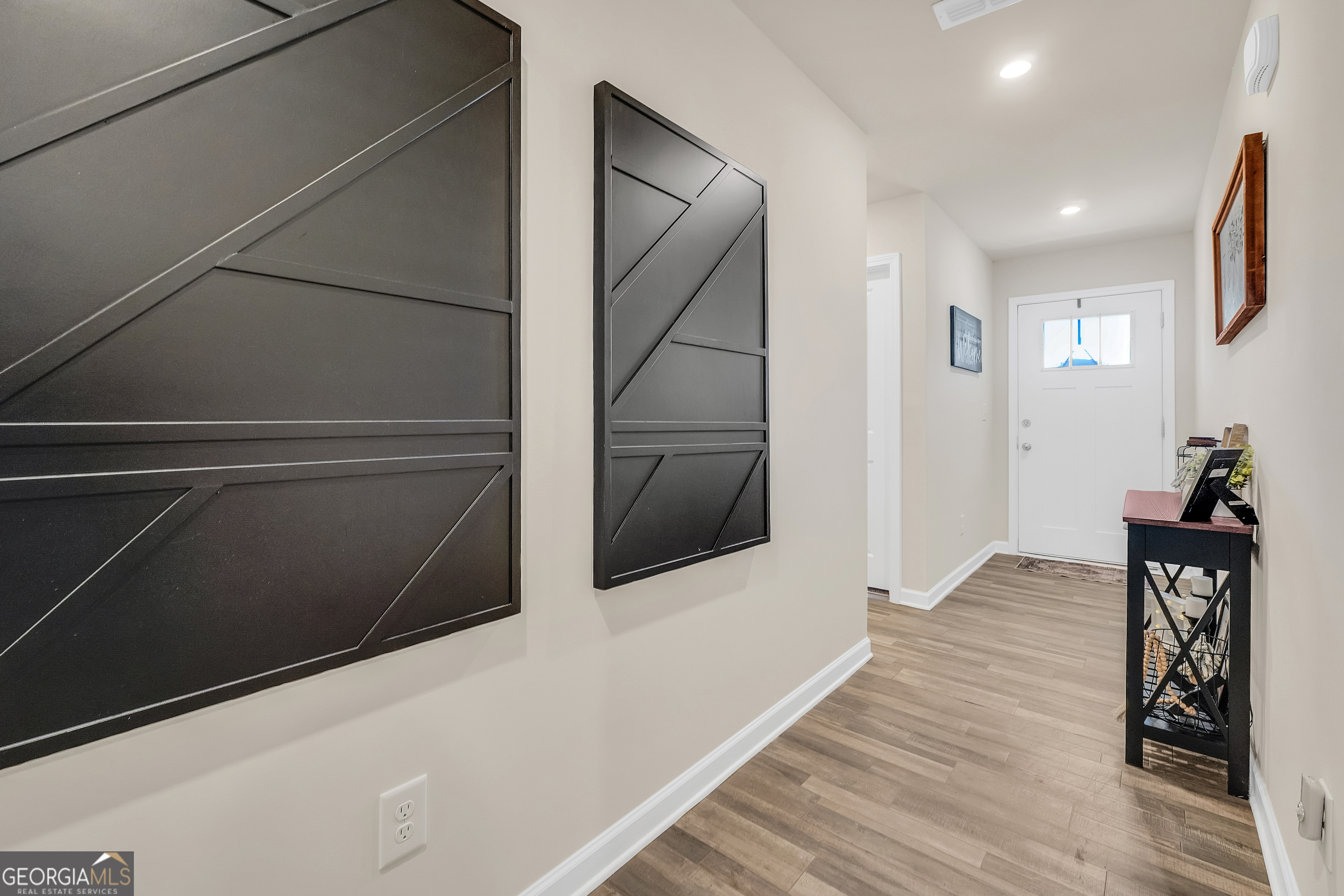 135 Catalpa Road Milner, GA 30257 - Photo 4 of 29 a view of a hallway with wooden floor and staircase