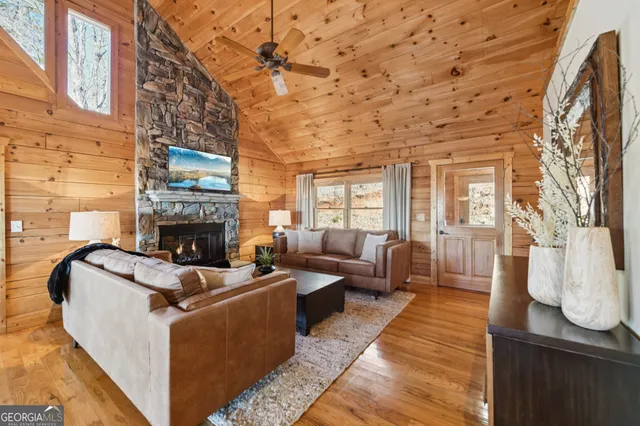 a living room with furniture and large windows