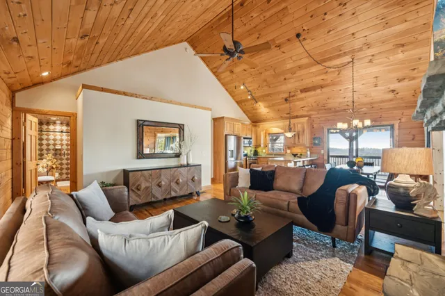 a living room with furniture and floor to ceiling windows