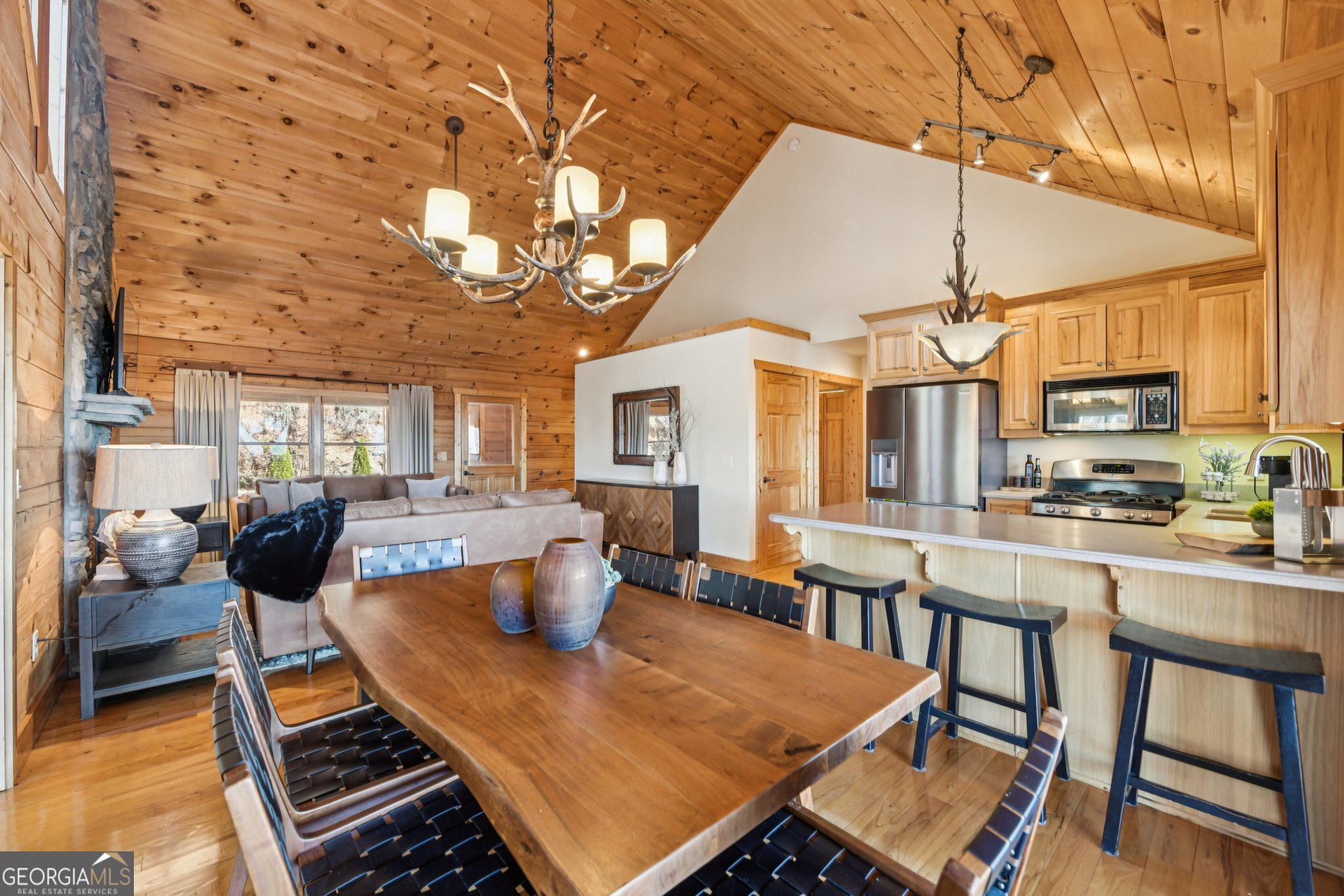 232 Ranch Mountain Drive Dahlonega, GA 30533 - Photo 17 of 78 a view of a dining room with furniture a chandelier and wooden floor