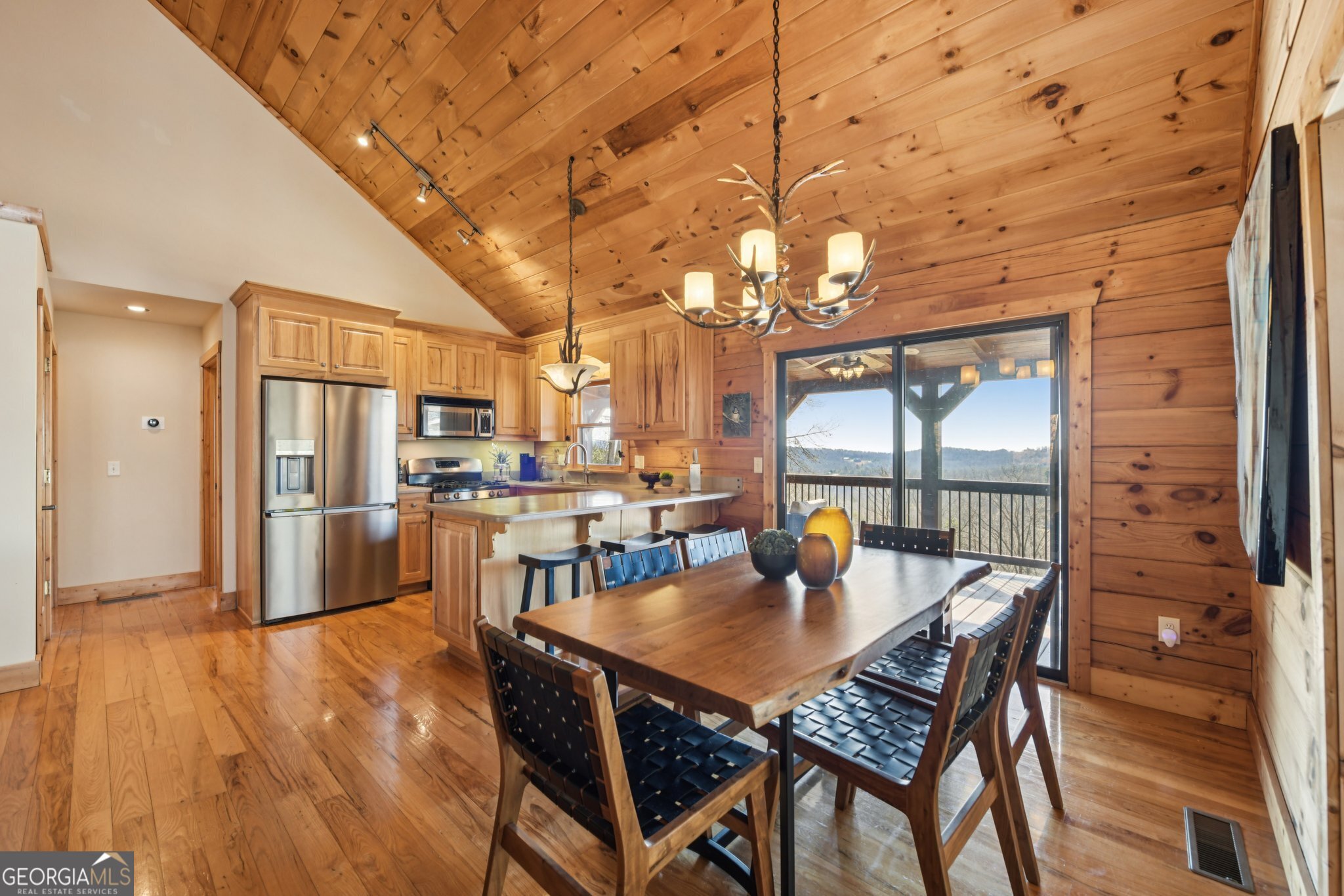 232 Ranch Mountain Drive Dahlonega, GA 30533 - Photo 18 of 78 a dining room with furniture a chandelier and wooden floor