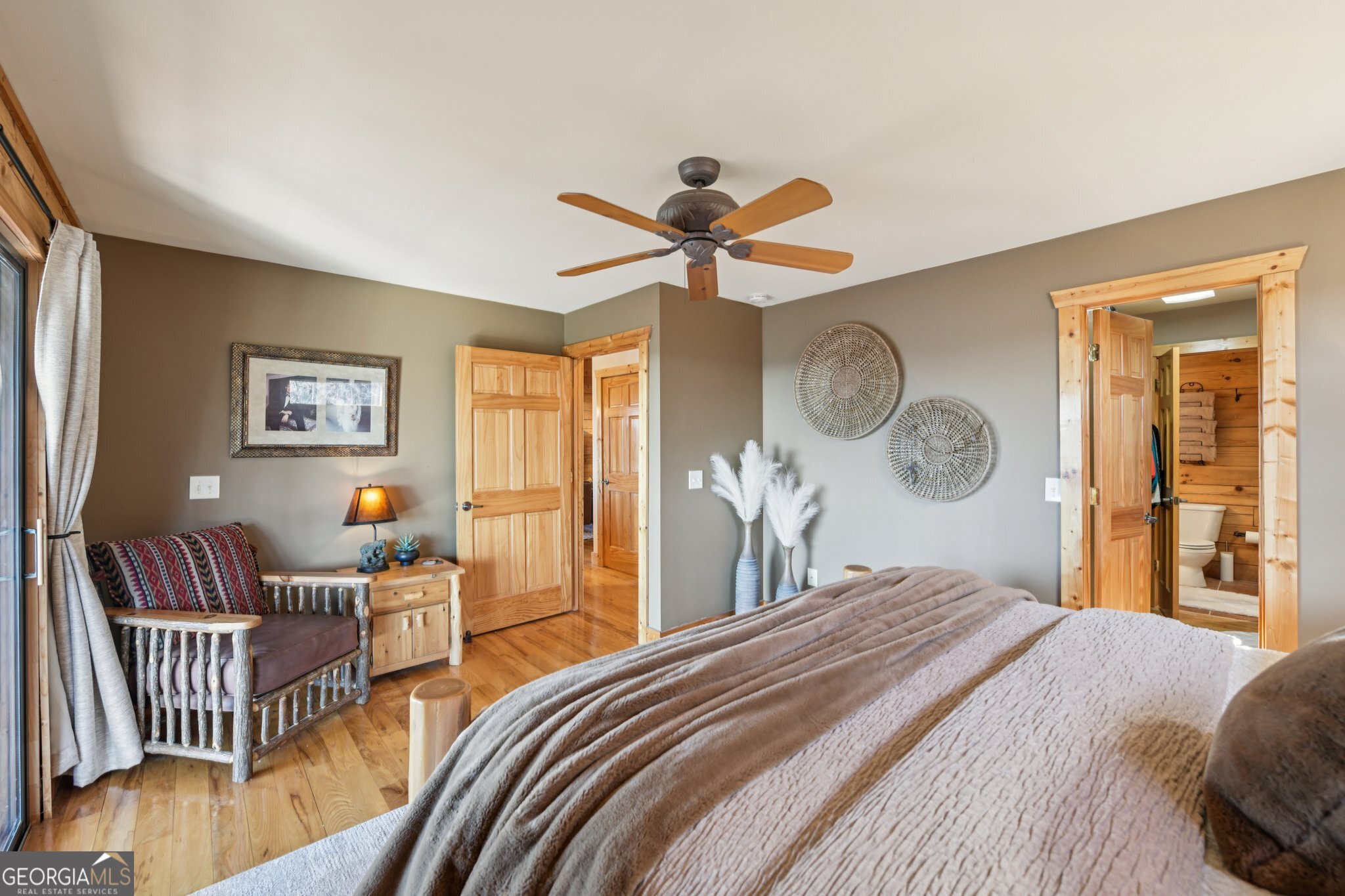 232 Ranch Mountain Drive Dahlonega, GA 30533 - Photo 29 of 78 a bedroom with a bed and a chandelier