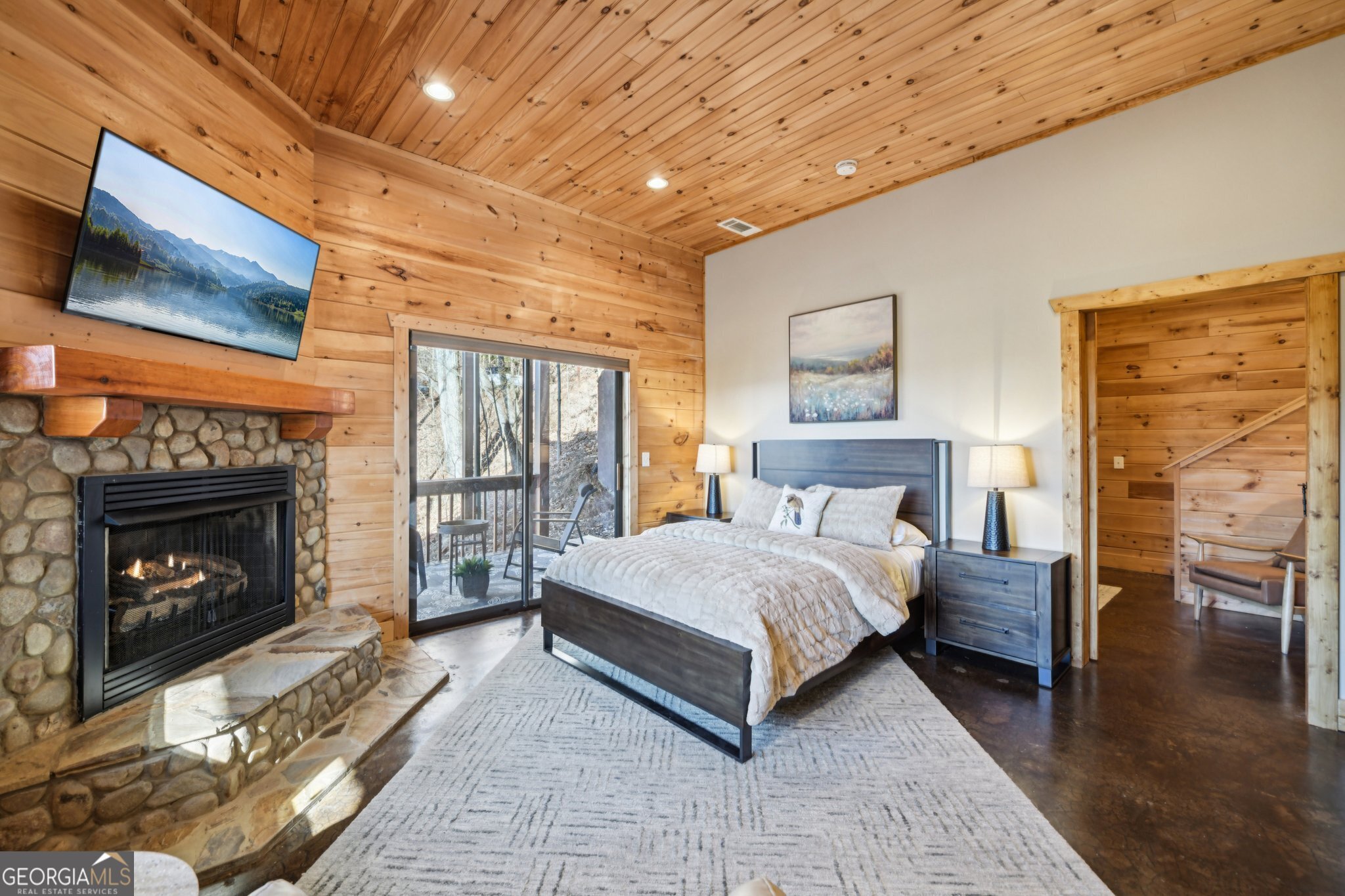 232 Ranch Mountain Drive Dahlonega, GA 30533 - Photo 38 of 78 a bed room with a bed and a fireplace