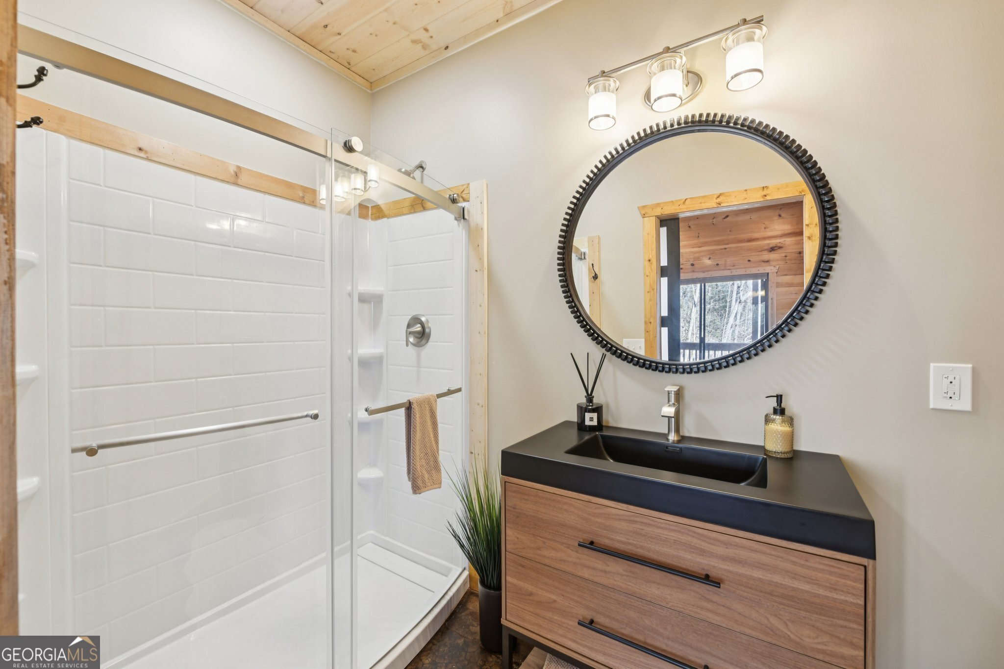 232 Ranch Mountain Drive Dahlonega, GA 30533 - Photo 40 of 78 a bathroom with a sink a mirror and a shower