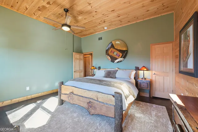 a view of the house with yard and tree s