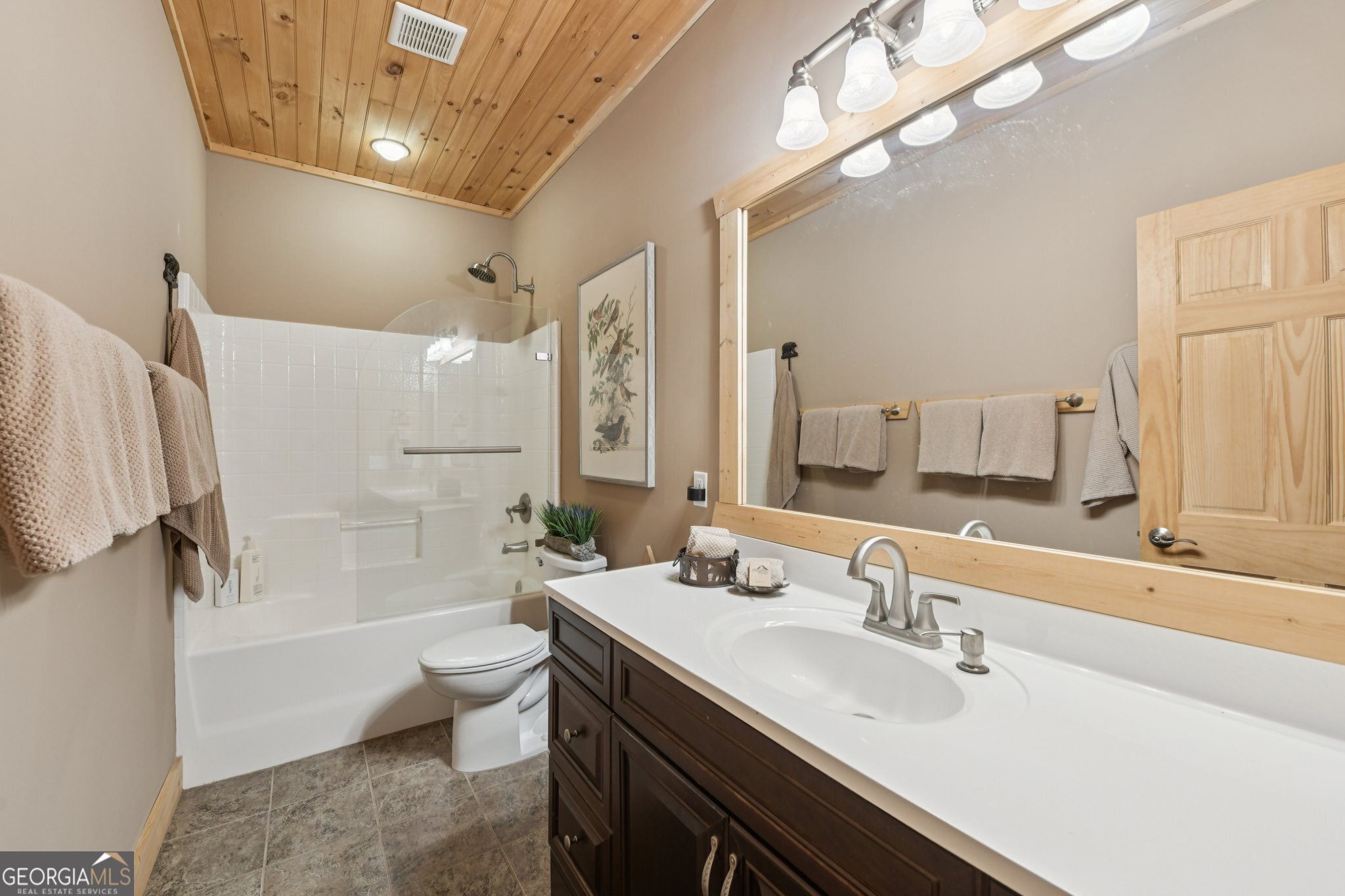232 Ranch Mountain Drive Dahlonega, GA 30533 - Photo 45 of 78 a bathroom with a granite countertop sink a toilet a mirror and shower