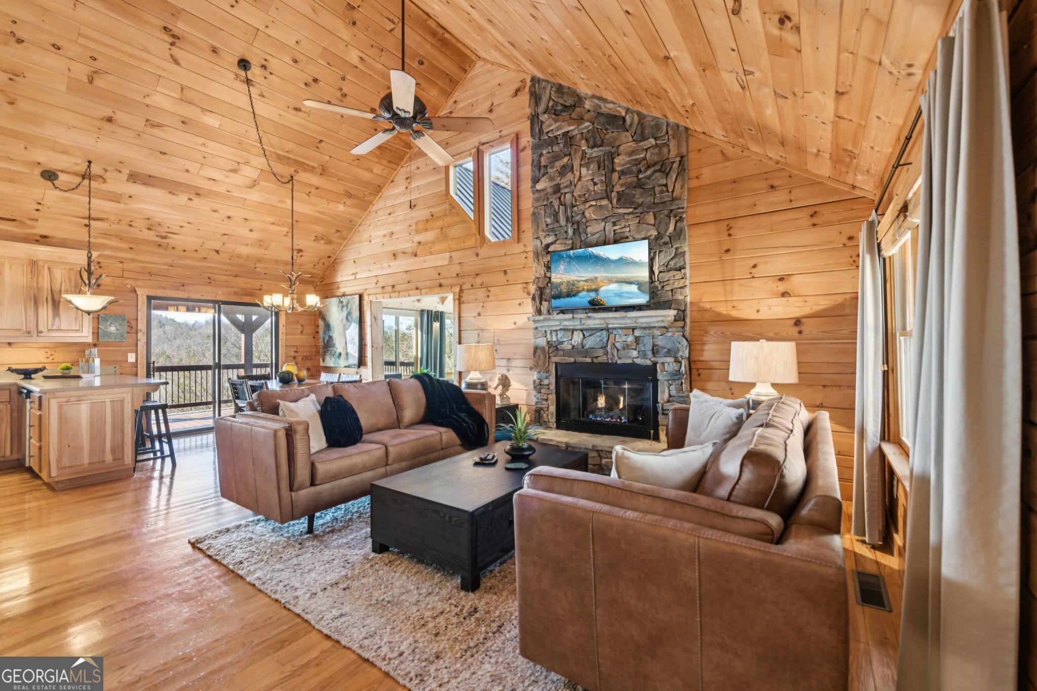 232 Ranch Mountain Drive Dahlonega, GA 30533 - Photo 10 of 78 a living room with furniture a fireplace and a floor to ceiling window
