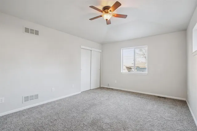 a view of room with a ceiling fan and window